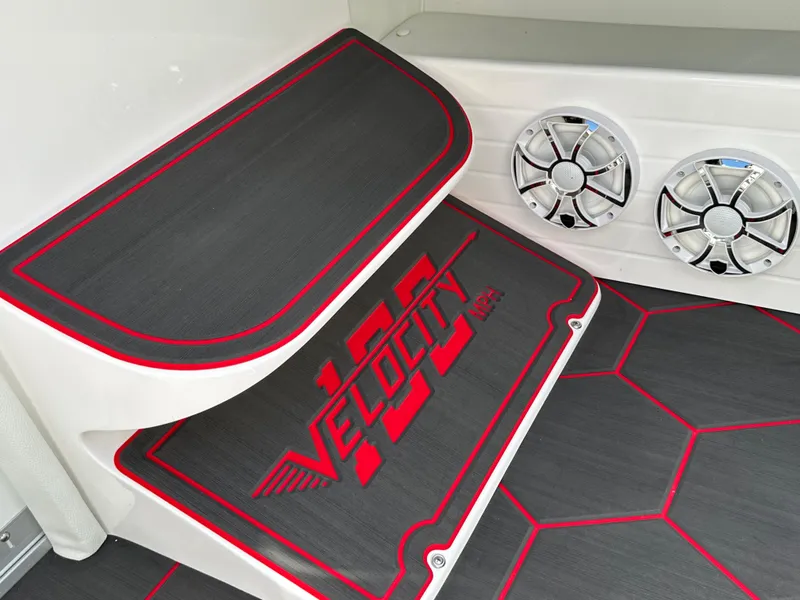 Slide: The Image of 2025 Velocity 290 SC boat interior with custom flooring and speakers. - 21