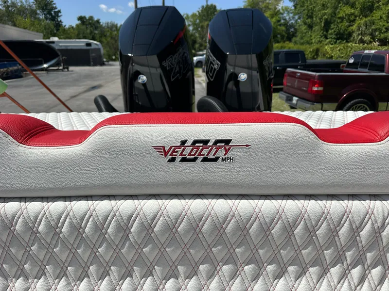 Slide: The Image of Velocity 290 SC 2025 boat interior with red and white upholstery, featuring 100 MPH branding. - 26