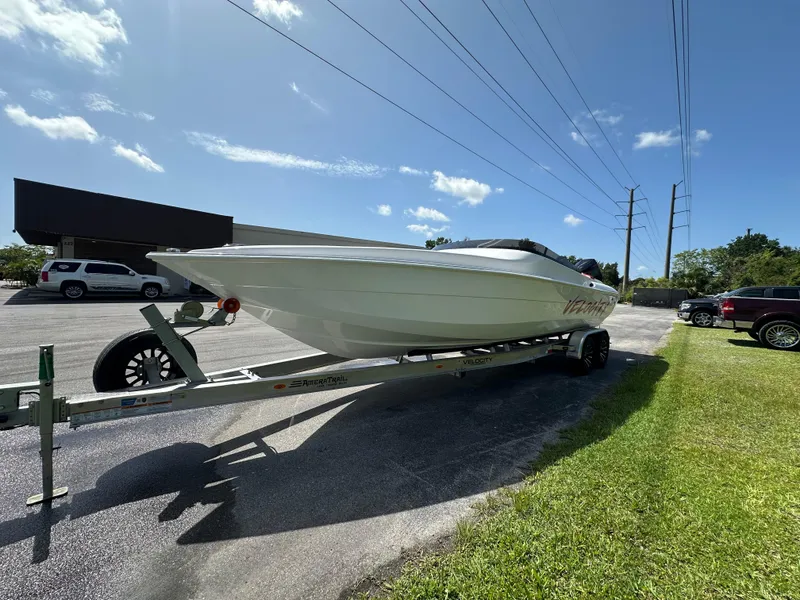 Slide: The Image of 2025 Velocity 290 SC boat on trailer under clear blue sky. - 3