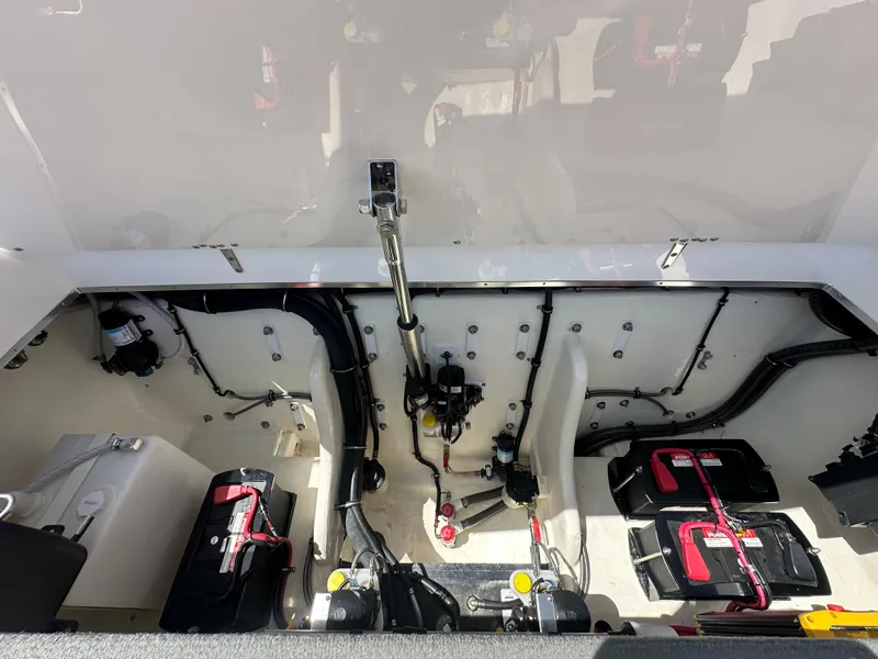 Slide: The Image of Engine compartment of 2025 Velocity 290 SC boat, showcasing batteries and wiring. - 31