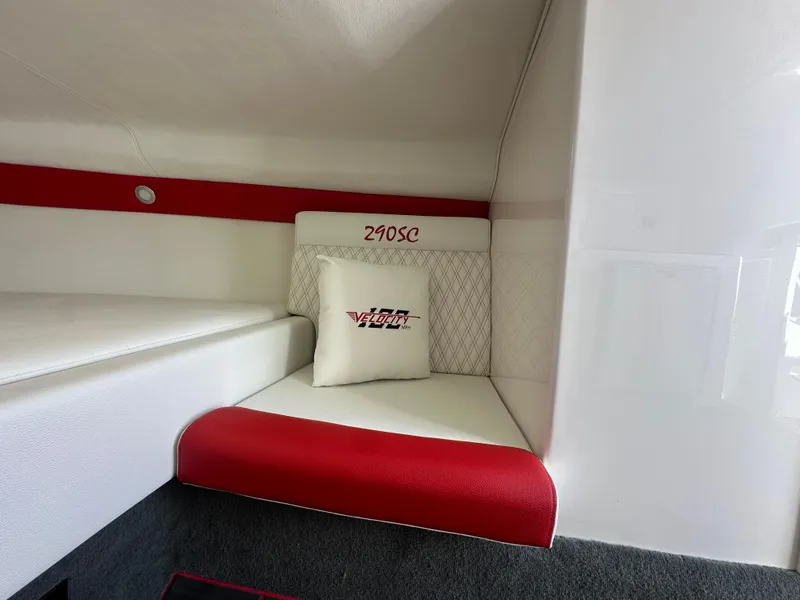 Slide: The Image of Interior of 2025 Velocity 290 SC boat with red and white seating. - 38