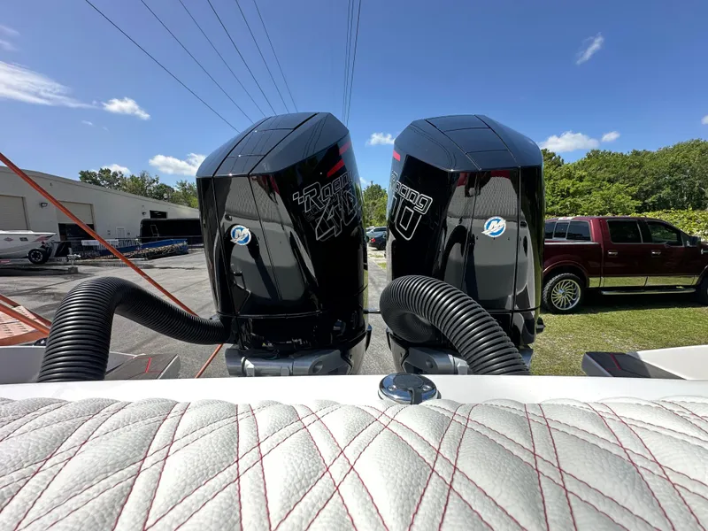 Slide: The Image of Twin Mercury Racing 450R engines on a 2025 Velocity 290 SC boat, sunny day backdrop. - 44