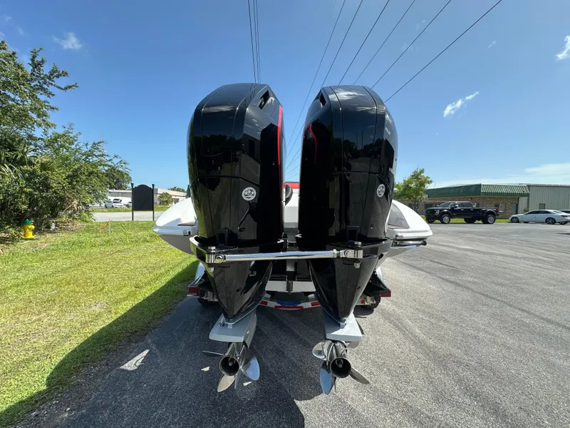 Slide: The Image of 2025 Velocity 290 SC boat with dual outboard motors on a sunny day. - 9