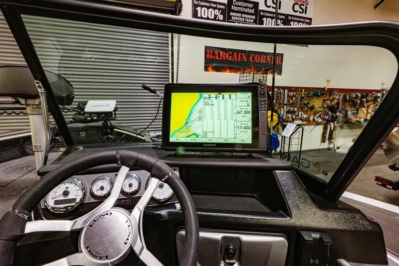 Slide: The Image of 2024 Lund 1875 Pro V Sport dashboard with Garmin GPS and control gauges. - 12