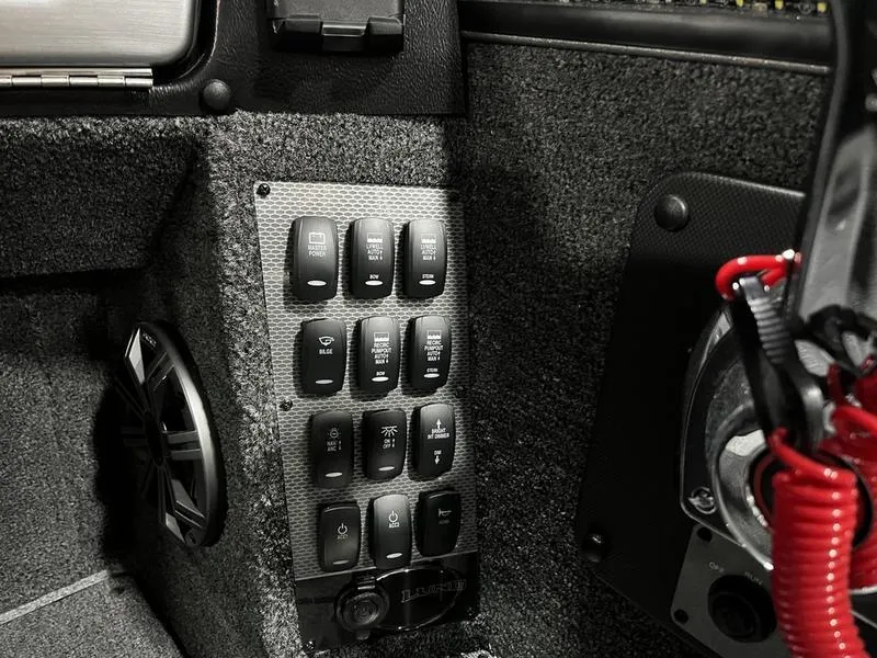Slide: The Image of Control panel of 2024 Lund 1875 Pro V Sport boat with various switches. - 8