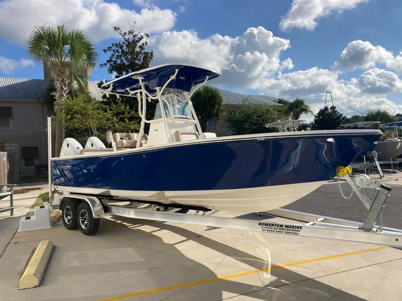 Slide: The Image of 2024 Sea Born LX24 boat on a trailer in a sunny marina. - 3