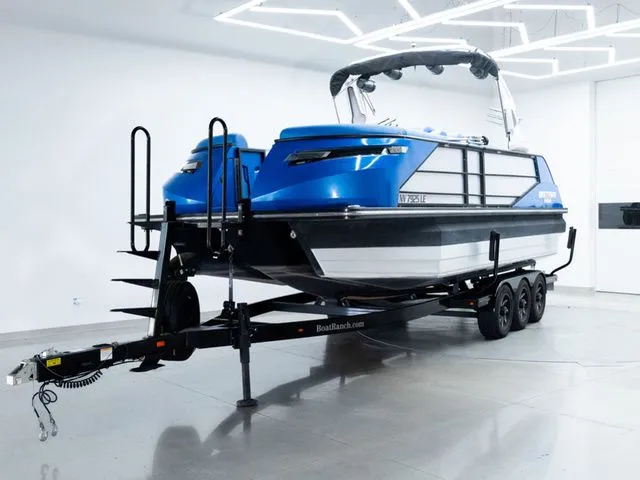 The Image of 2023 Montara 25' SURF BOSS 2.0 CW boat on trailer in showroom. - 1
