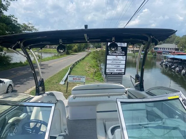 Slide: The Image of 2021 Cobalt R5 boat docked near a boat launch sign. - 12