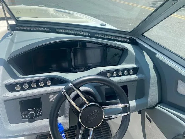 Slide: The Image of 2021 Cobalt R5 boat dashboard with steering wheel and control panel. - 15