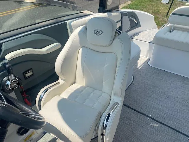 Slide: The Image of 2021 Cobalt R5 boat interior with white leather captain's chair and modern dashboard. - 7