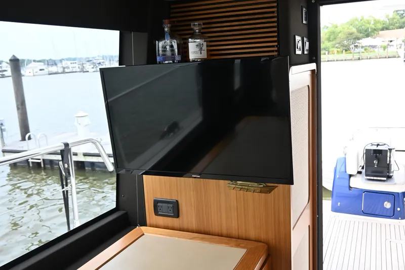 Slide: The Image of Interior of 2014 Azimut Magellano 50 yacht with TV and marina view. - 13