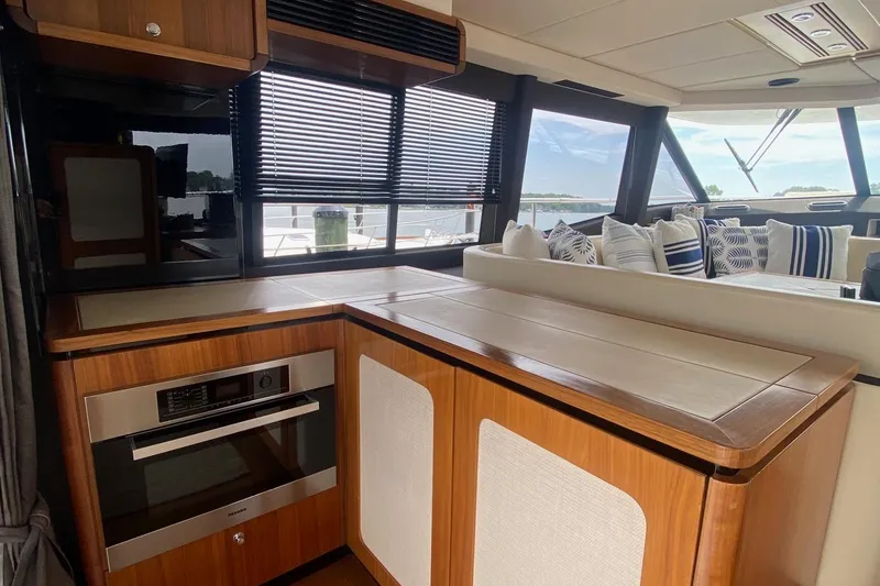 Slide: The Image of Interior of 2014 Azimut Magellano 50 yacht with modern kitchen and seating area. - 14