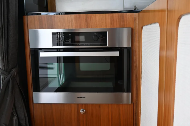 Slide: The Image of Miele oven in 2014 Azimut Magellano 50 yacht kitchen, wood paneling. - 19