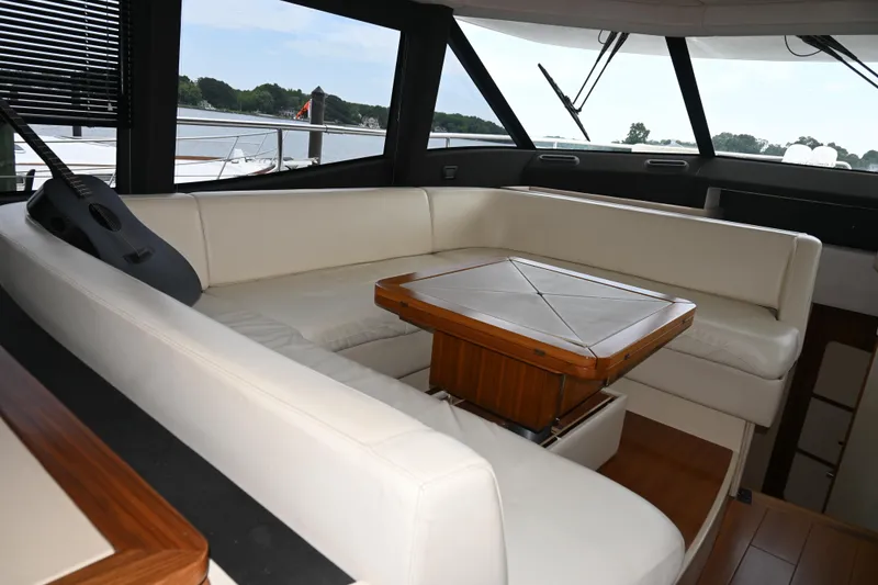 Slide: The Image of Luxurious interior of 2014 Azimut Magellano 50 yacht with white seating and wooden table. - 21