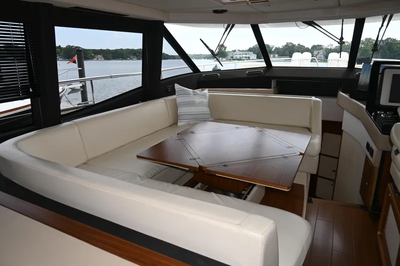 Slide: The Image of Luxurious interior of 2014 Azimut Magellano 50 yacht with elegant seating and wooden table. - 22
