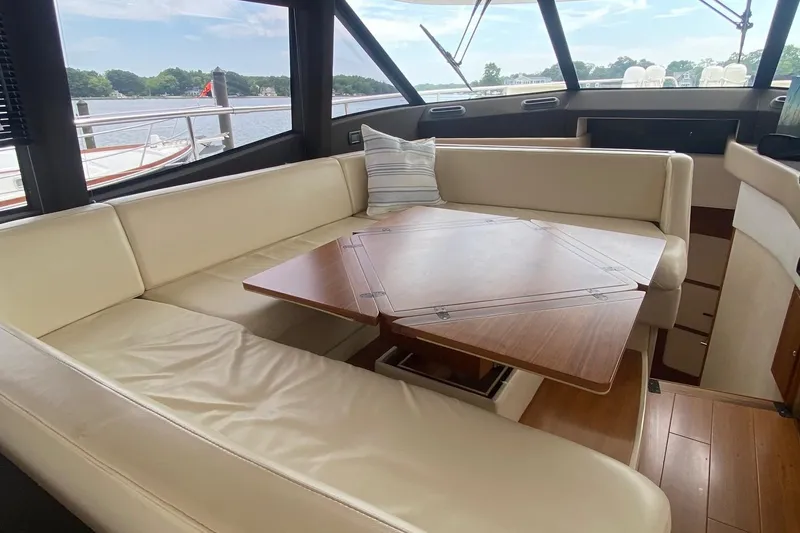 Slide: The Image of Luxurious interior of 2014 Azimut Magellano 50 yacht with cream leather seating and wooden table. - 23