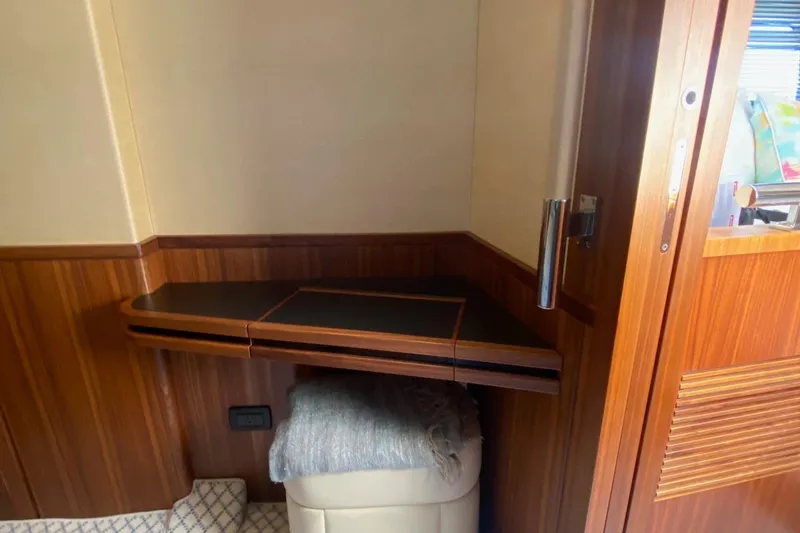 Slide: The Image of Azimut Magellano 50 yacht interior, 2014 model, featuring wooden paneling and a compact seating area. - 38