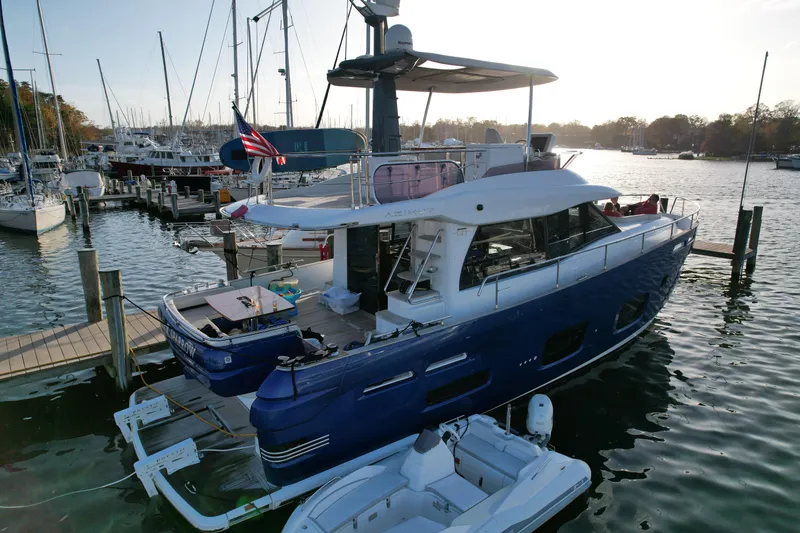 Slide: The Image of Azimut Magellano 50 yacht, 2014 model, docked in a marina with surrounding boats. - 7