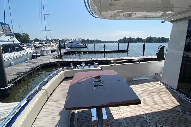 Slide: The Image of Azimut Magellano 50 yacht deck, 2014 model, docked at marina with scenic water view. - 8
