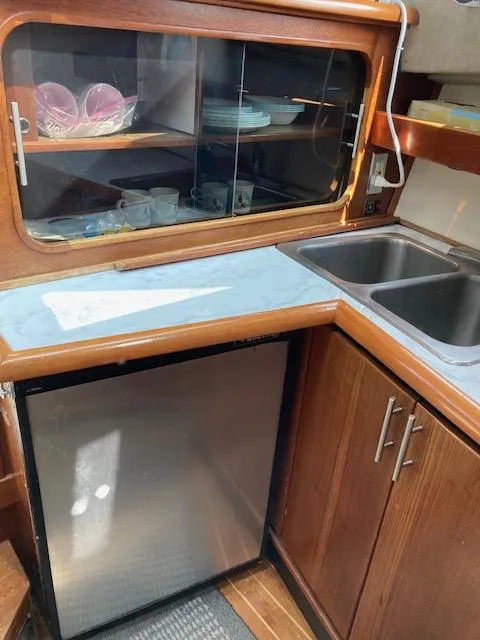 Slide: The Image of Bayliner 3288 Motoryacht 1990 kitchen with sink, fridge, and cabinets. - 10