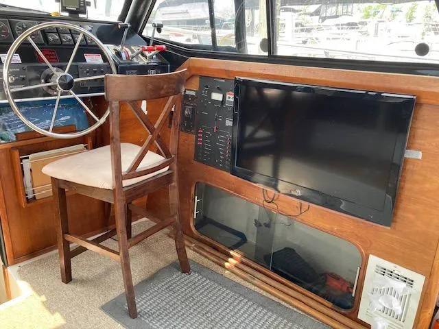 Slide: The Image of Interior helm station of a 1990 Bayliner 3288 Motoryacht with steering wheel and control panel. - 13