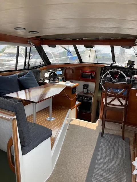 Slide: The Image of Interior of a 1990 Bayliner 3288 Motoryacht with helm and seating area. - 2