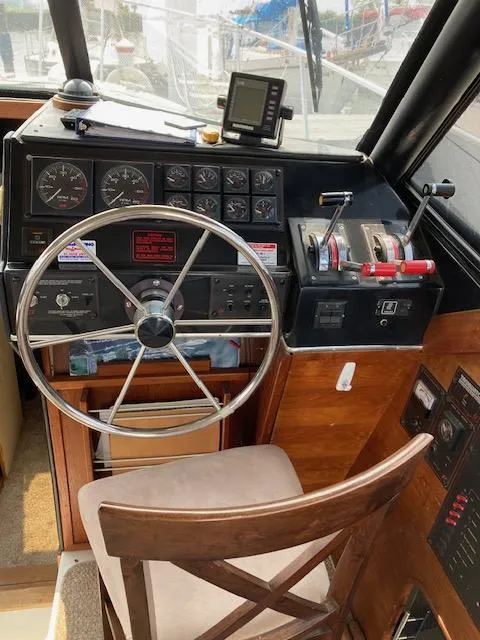 Slide: The Image of Bayliner 3288 Motoryacht 1990 helm station with steering wheel and controls. - 4