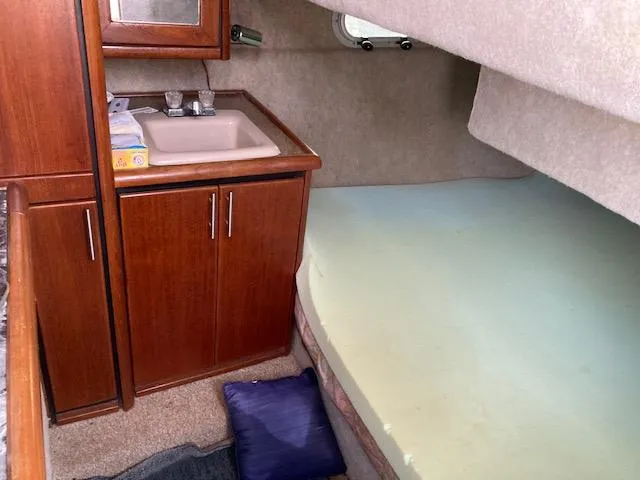 Slide: The Image of 1990 Bayliner 3288 Motoryacht interior cabin with sink and bed. - 7