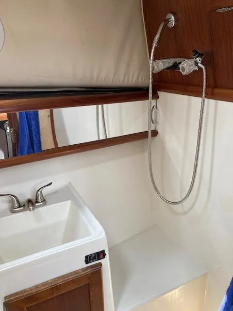 Slide: The Image of Bathroom sink and shower area in a 1990 Bayliner 3288 Motoryacht. - 9