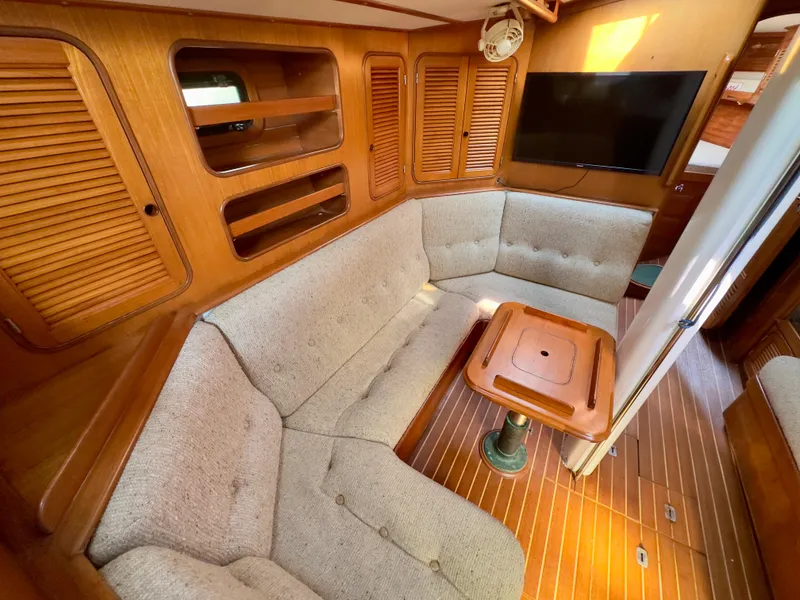 Slide: The Image of Interior of 1983 Norseman 447 CC Cutter with cozy seating and wooden finishes. - 11