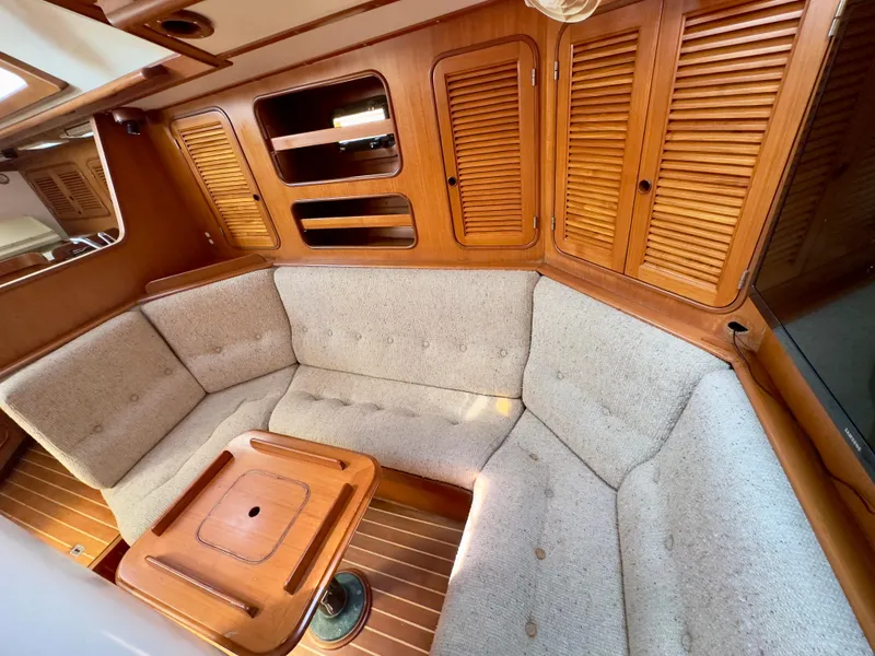 Slide: The Image of Interior of 1983 Norseman 447 CC Cutter with cozy seating and wooden accents. - 12
