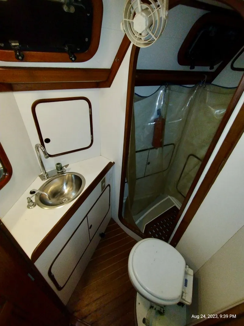 Slide: The Image of 1983 Norseman 447 CC Cutter bathroom with sink, toilet, and shower. - 25