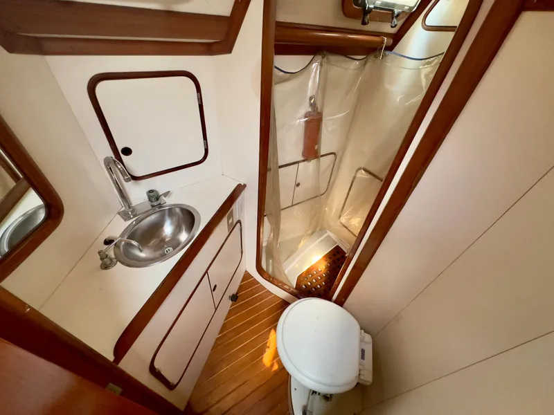 Slide: The Image of Compact bathroom in 1983 Norseman 447 CC Cutter, featuring sink, toilet, and shower. - 28