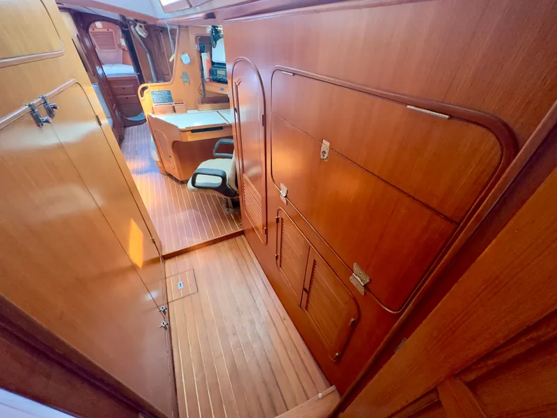Slide: The Image of Interior of 1983 Norseman 447 CC Cutter, featuring wooden paneling and seating area. - 29