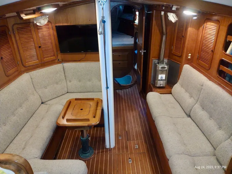 Slide: The Image of Interior of 1983 Norseman 447 CC Cutter with cozy seating and wooden finishes. - 4