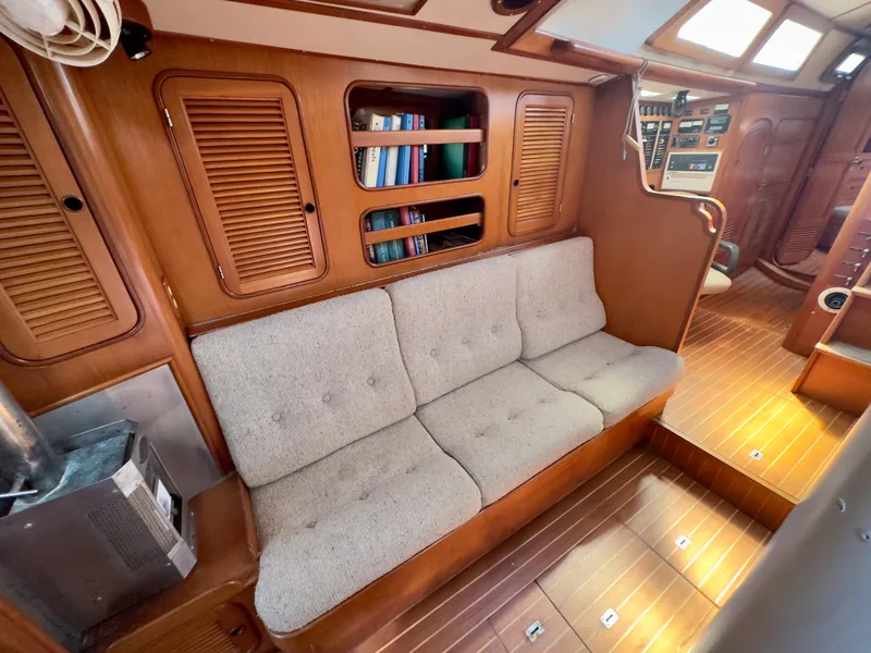 Slide: The Image of Interior of 1983 Norseman 447 CC Cutter with wooden paneling and cushioned seating. - 7