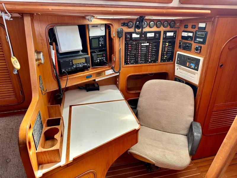 Slide: The Image of Navigation station of 1983 Norseman 447 CC Cutter with control panels and equipment. - 9