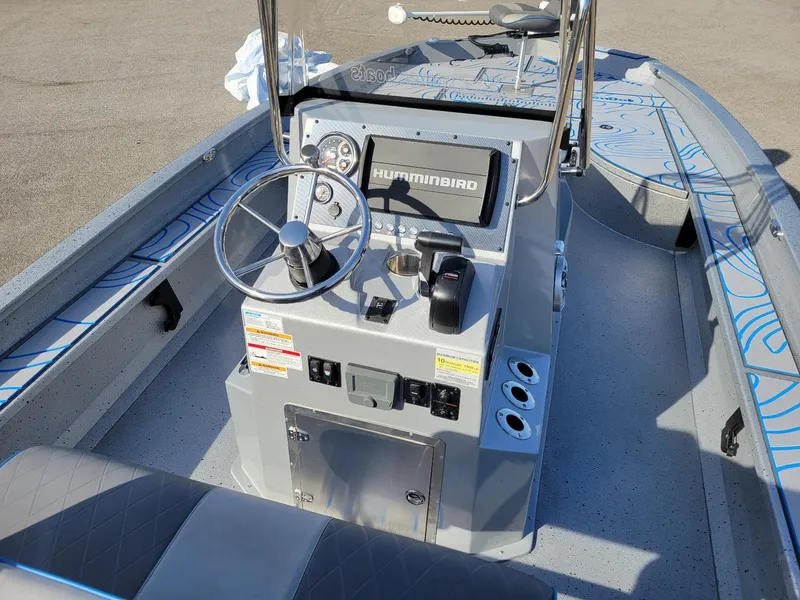 Slide: The Image of 2024 Xpress X23 Bay Lounge boat interior with steering wheel and control panel. - 10