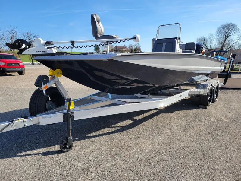 Slide: The Image of 2024 Xpress X23 Bay Lounge boat on trailer, featuring Minn Kota motor. - 12