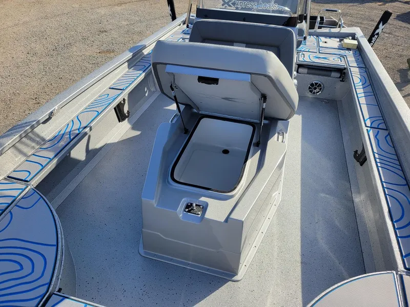 Slide: The Image of 2024 Xpress X23 Bay Lounge boat interior with open storage compartment. - 16