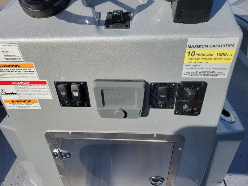 Slide: The Image of 2024 Xpress X23 Bay Lounge control panel with capacity and warning labels. - 18