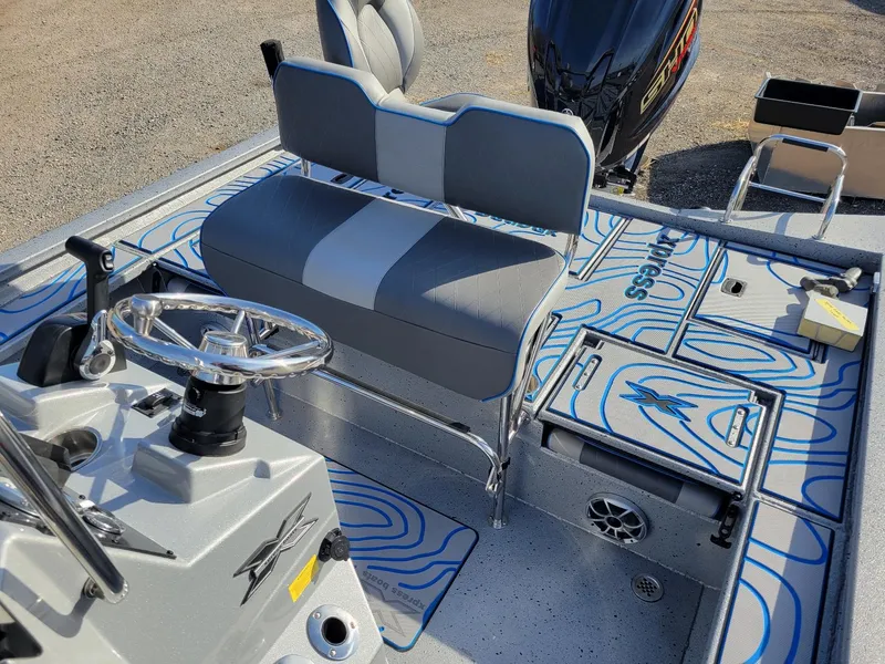 Slide: The Image of 2024 Xpress X23 Bay Lounge boat interior with steering wheel and seating. - 19