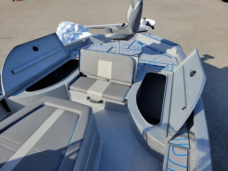 Slide: The Image of 2024 Xpress X23 Bay Lounge boat interior with seating and storage compartments. - 4