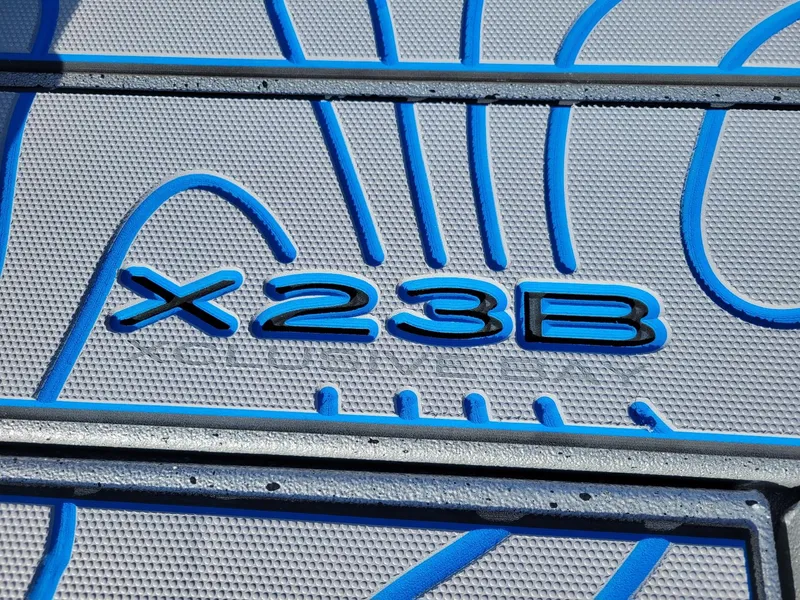 Slide: The Image of 2024 Xpress X23 Bay Lounge boat logo with blue accents. - 6