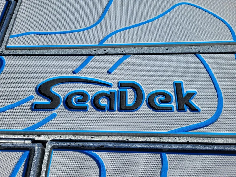 Slide: The Image of SeaDek logo on 2024 Xpress X23 Bay Lounge boat flooring. - 7