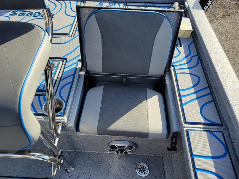 Slide: The Image of 2024 Xpress X23 Bay Lounge boat seat with blue accents and storage compartment. - 9