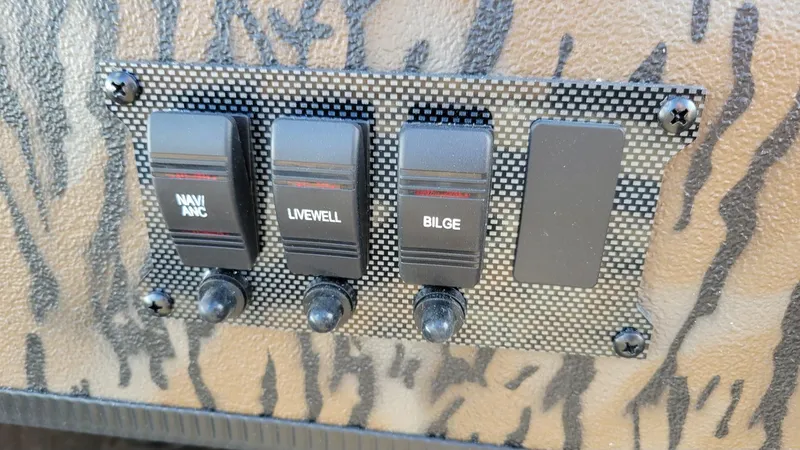 Slide: The Image of Control panel of 2025 Xpress XP18CC boat with switches for navigation, livewell, and bilge. - 13