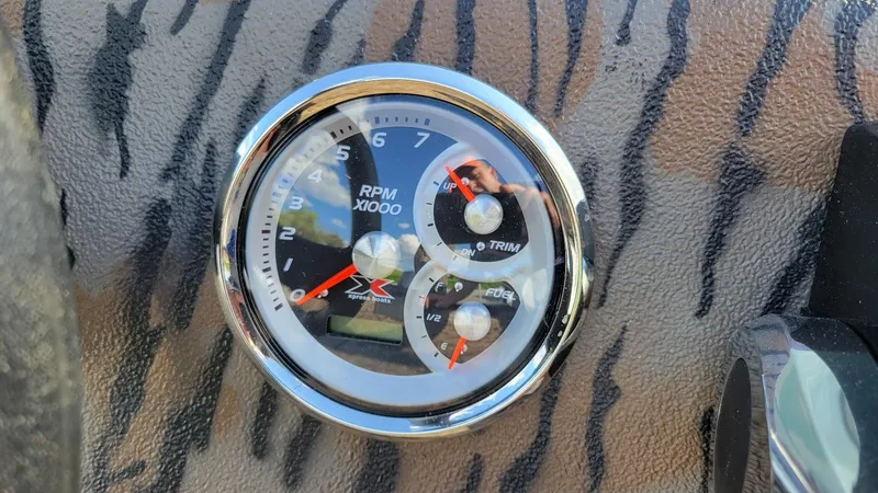 Slide: The Image of Tachometer on 2025 Xpress XP18CC boat with tiger stripe pattern dashboard. - 8