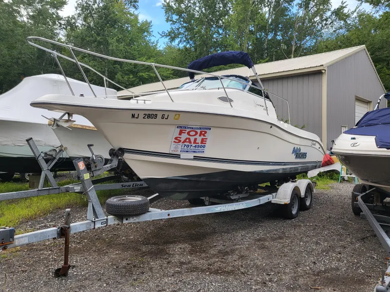 Slide: The Image of 1998 Seaswirl 2300 Walkaround boat for sale on trailer, parked outdoors. - 11