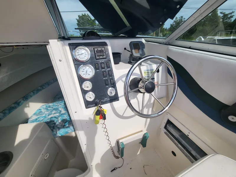 Slide: The Image of 1998 Seaswirl 2300 Walkaround boat interior with steering wheel and instrument panel. - 15